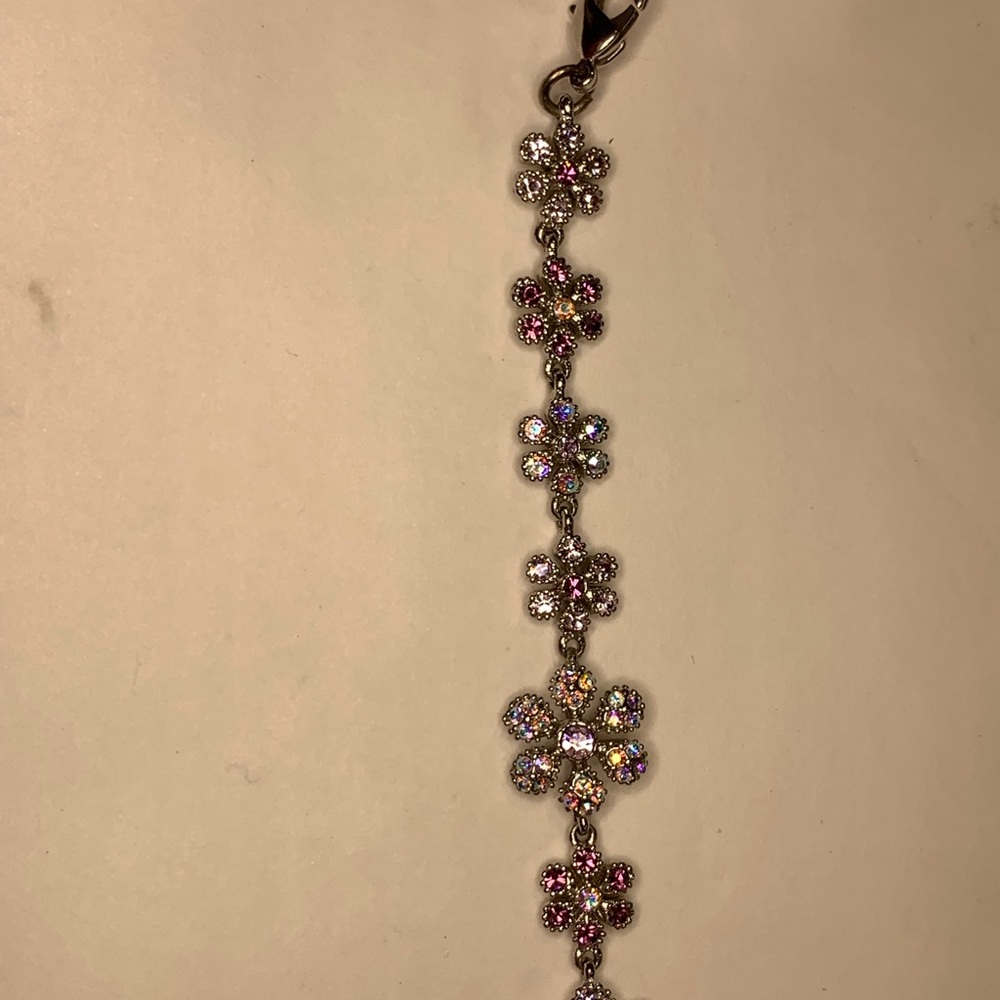 Pink and white gem flower and silver tone bracelet.